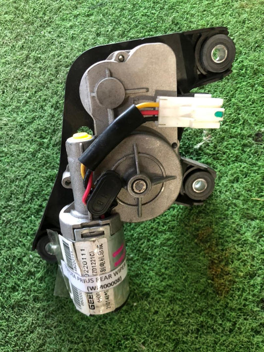 Car window motor on a green grass background